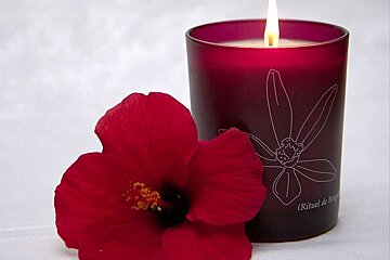 a photo of a flower and a candle at a mallorca spa