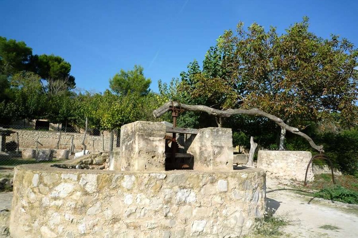 a photo of an ancient olive press in majorca