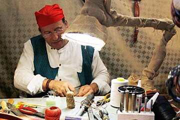 a photo of a mallorcan craftsman at work