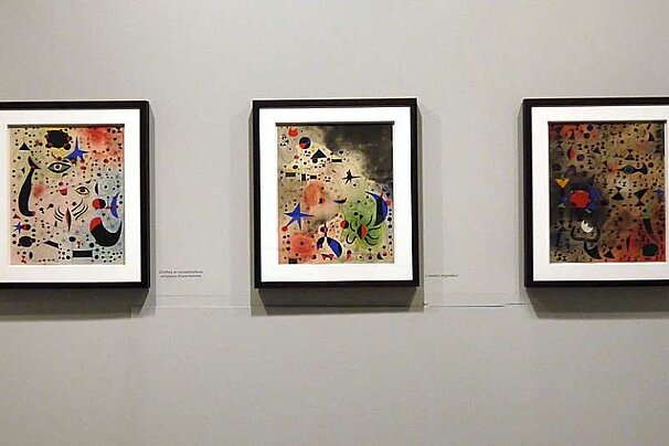 a photo of three paintings by miro