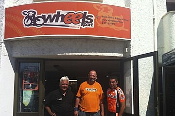a photo of men outside a shop