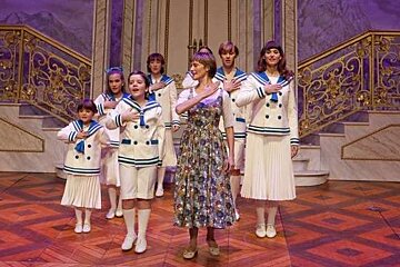 a photo of a family singing on stage