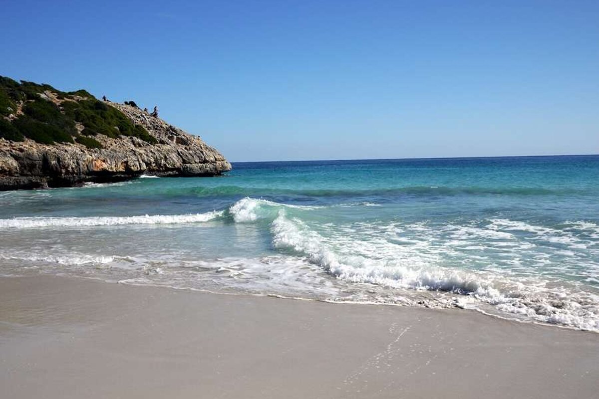 a photo of waves on a beach in majorca