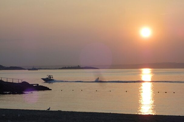 sunrise with wakeboarder in foreground