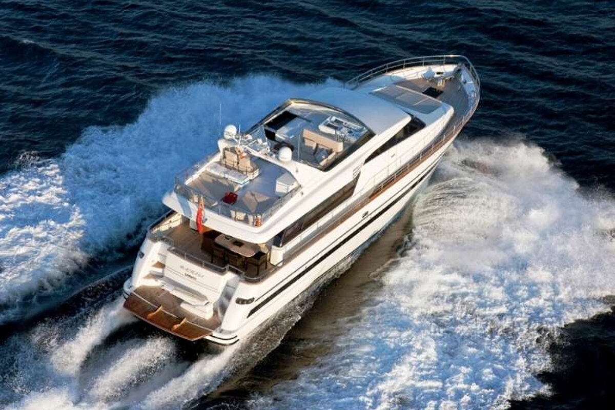 an image of a large luxury motor yachting powering its way over the sea