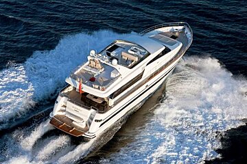 an image of a large luxury motor yachting powering its way over the sea