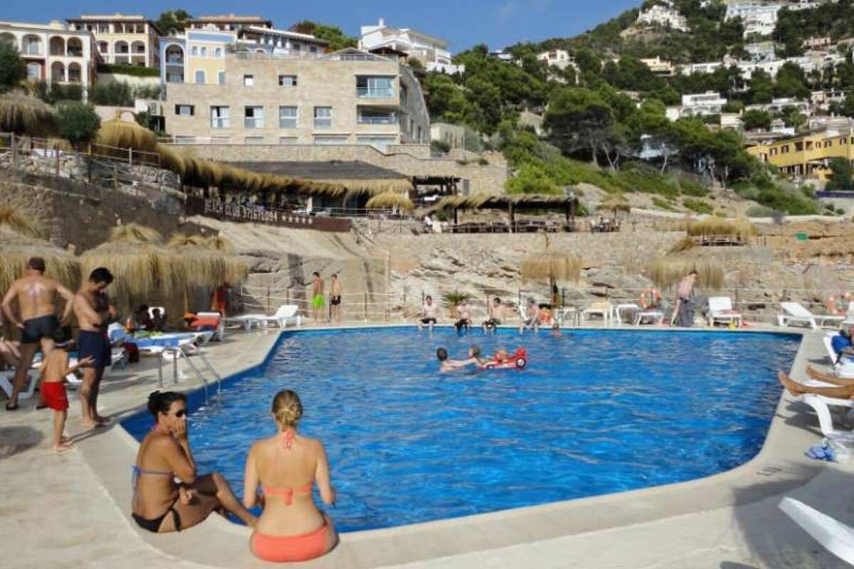 sitting by the pool with hills in background