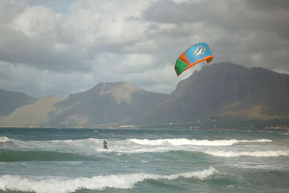 a photo of a kite surfer in the sea of majorca