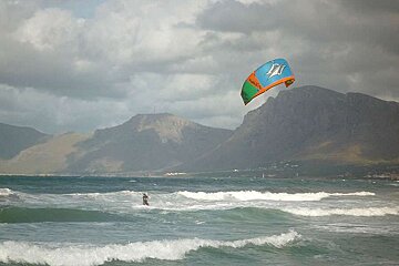 a photo of a kite surfer in the sea of majorca
