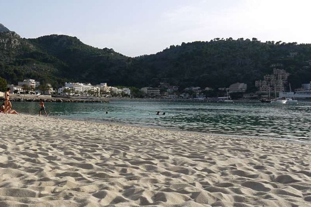photo of a beach will hills in background