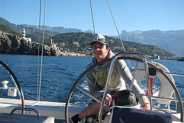 a photo of a skipper and a yacht at sea