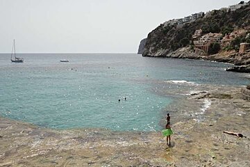 bay with clear water and some boats