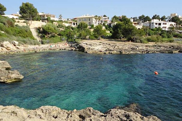 A large body of water with houses in the background
