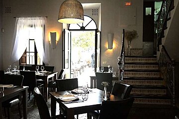 a photo of a dining room and stairs