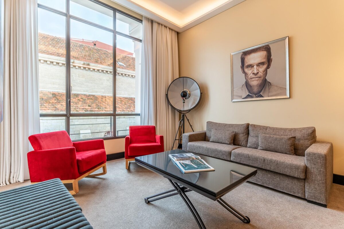 A living room with a picture of a man on the wall