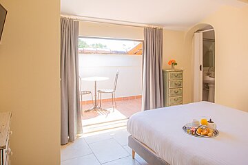 A bedroom with a tray of food on the bed