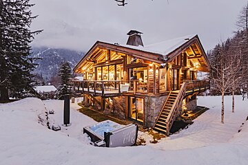 A large house with a hot tub in front of it