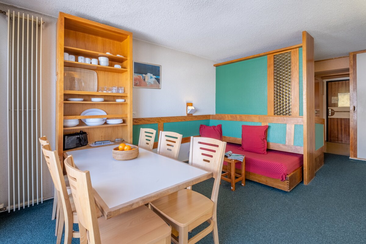 A living room with a table and chairs and a couch