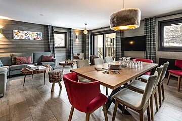 A living room with a dining table and chairs