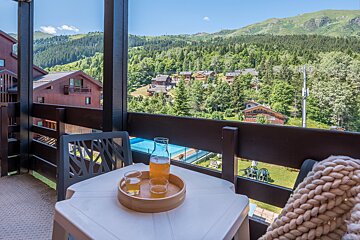 A table with two glasses and a pitcher of beer on it