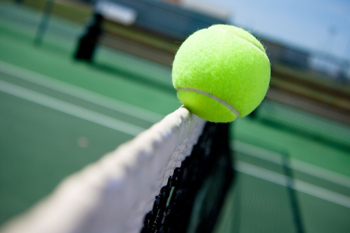 a tennis ball hitting the net