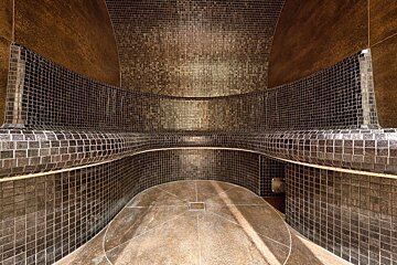 A mosaic tiled room with a circular floor