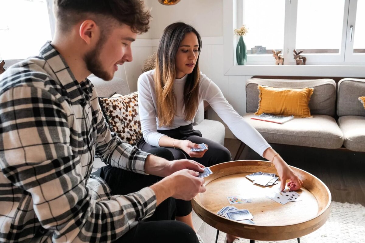 A man and a woman are playing a game of cards