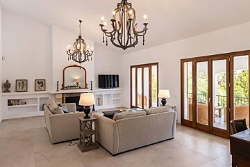 A living room with a fireplace and a chandelier