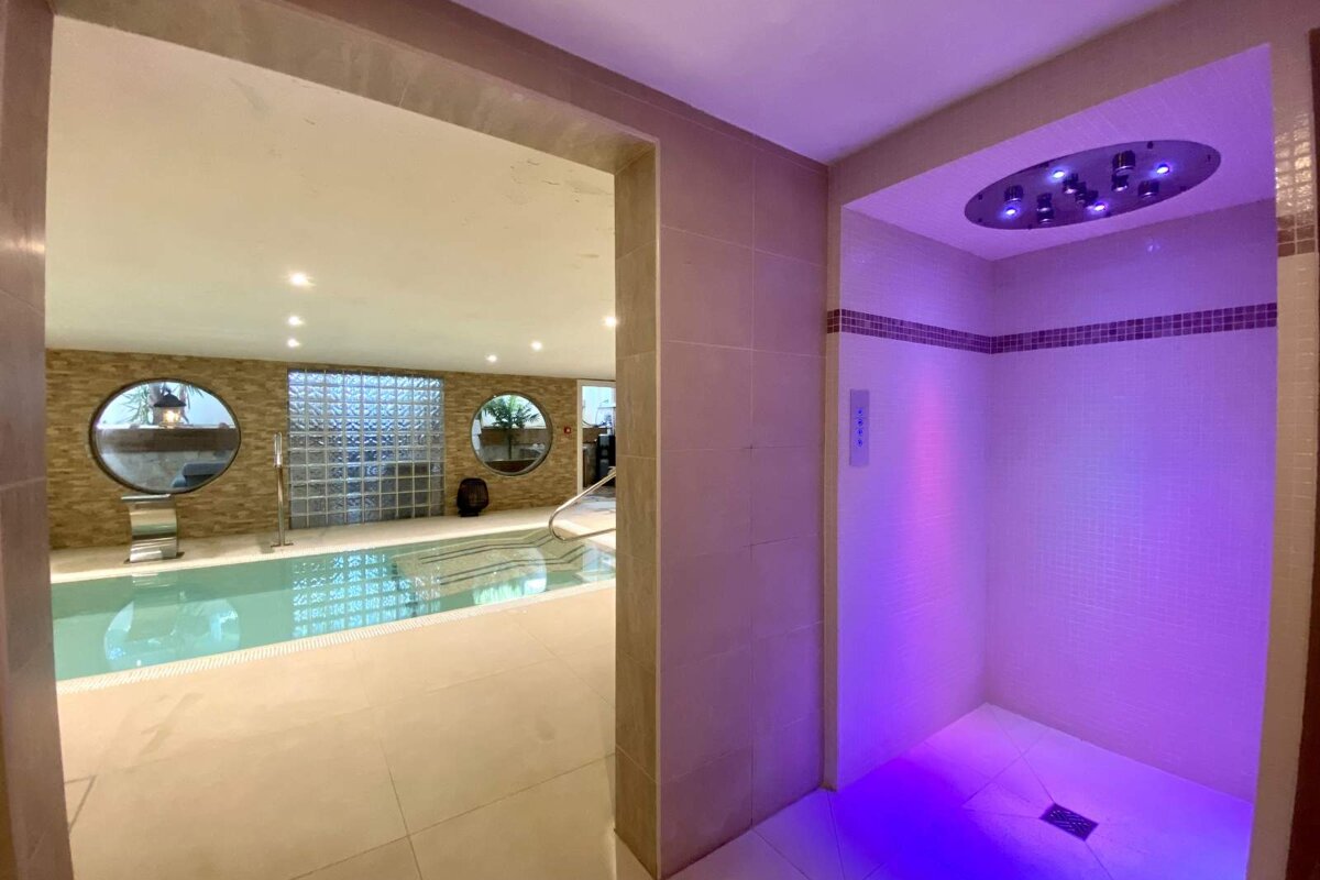 A bathroom with a shower and a swimming pool