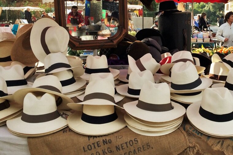 hats on a market stall in st tropez