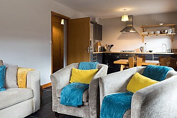 A living room with two chairs and a couch
