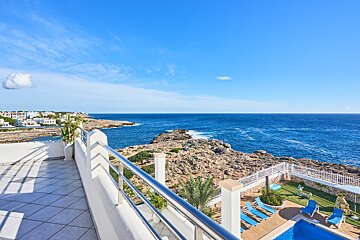 A balcony overlooking a large body of water