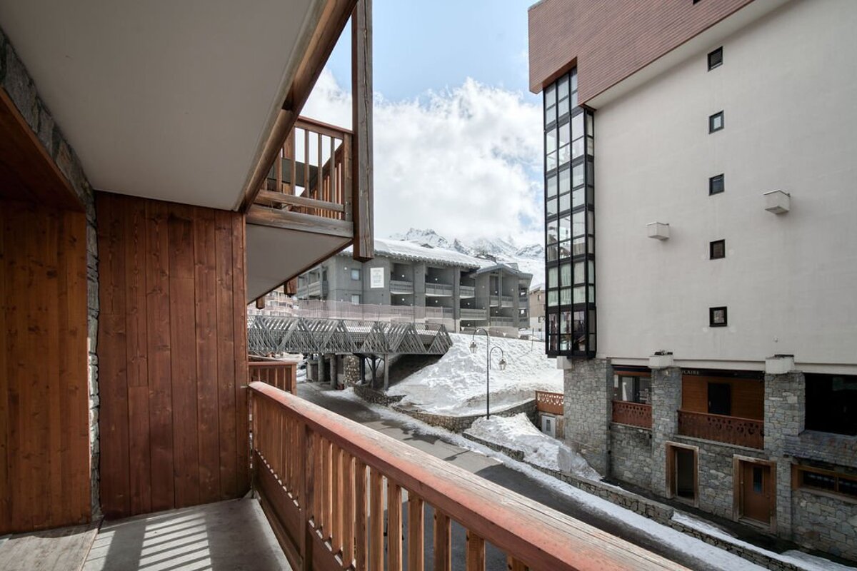 A balcony with a view of a snowy mountain
