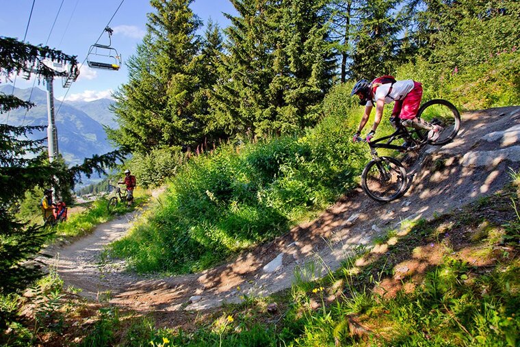 a female mountain biker on a steep section in les arcs