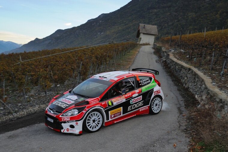 A red and black race car with the word edge on the side