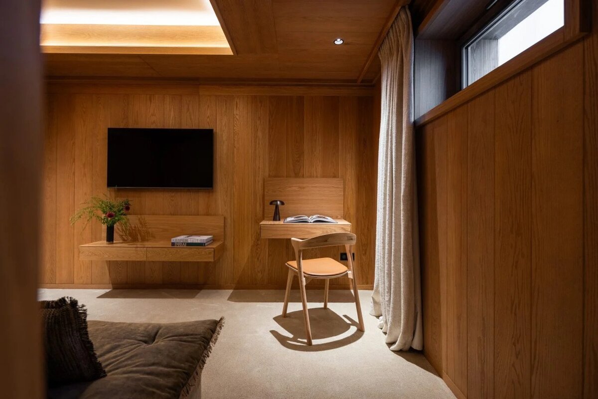 A wooden room with a chair and a desk