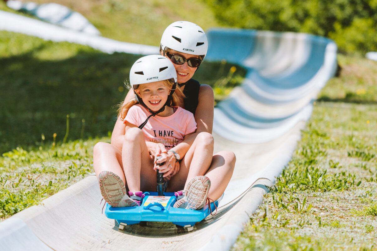 Woman and child on summer luge in morzine