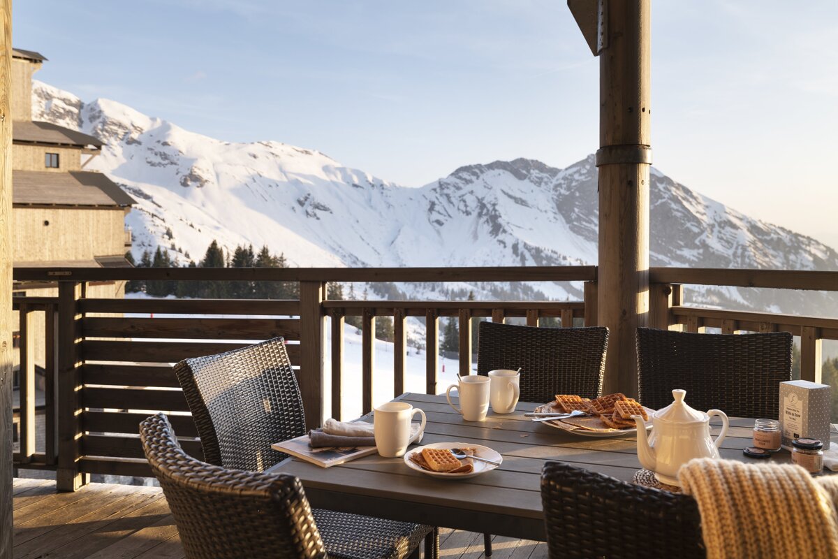 A table with a view of a snowy mountain