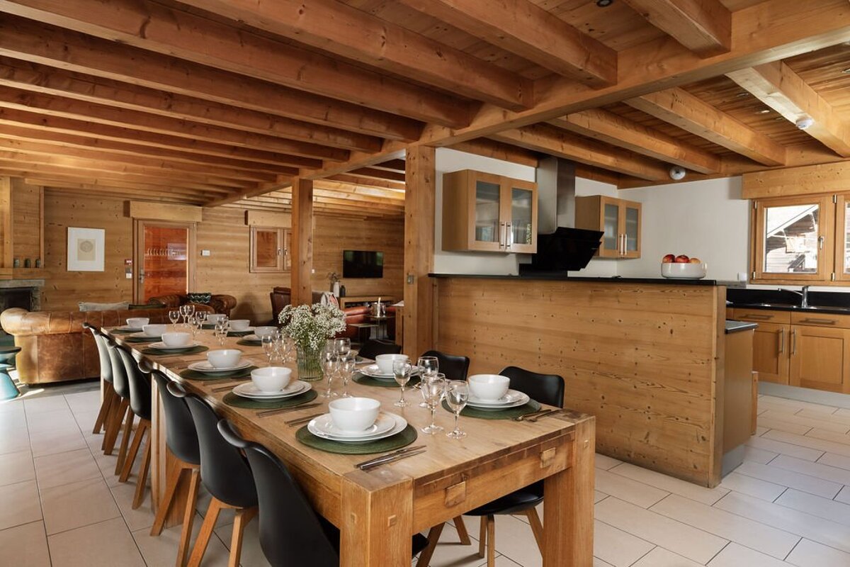 A dining room table with plates and glasses on it