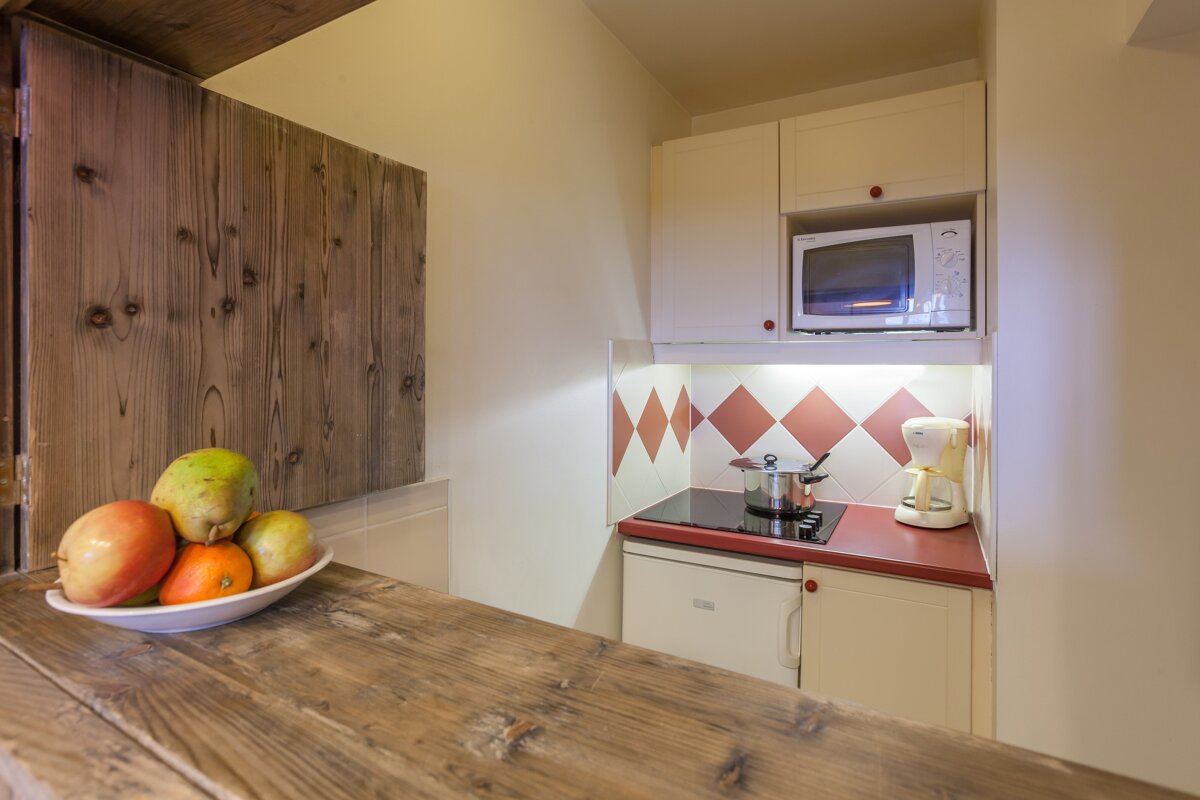 A small kitchen with a microwave and a coffee maker