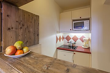 A small kitchen with a microwave and a coffee maker