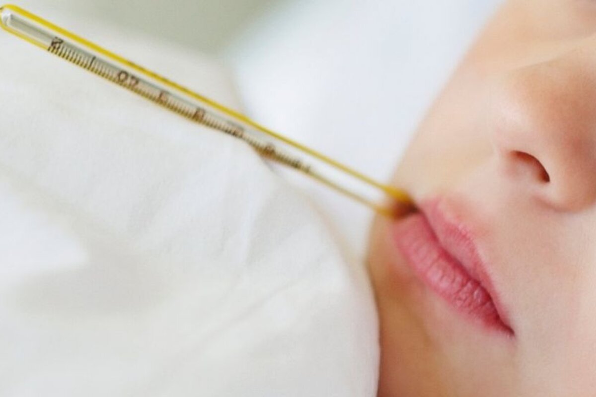 girl with thermometer in her mouth