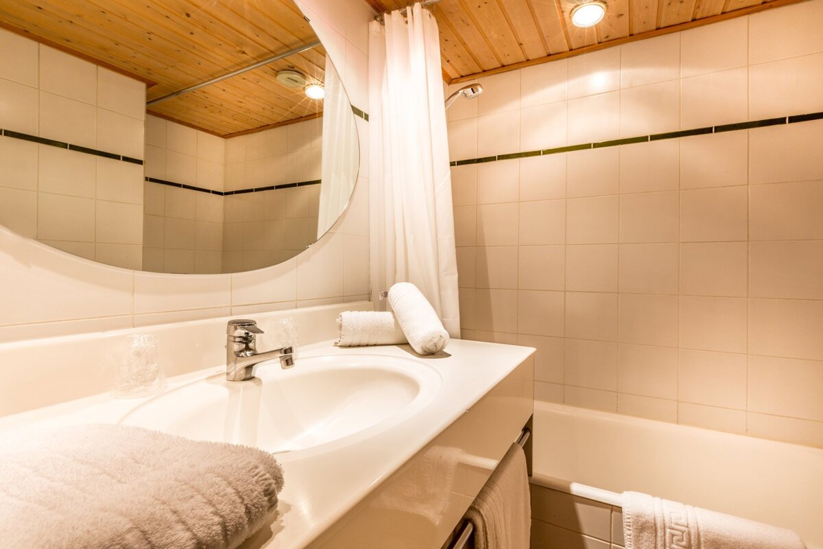 A bathroom with a sink a mirror and a bathtub