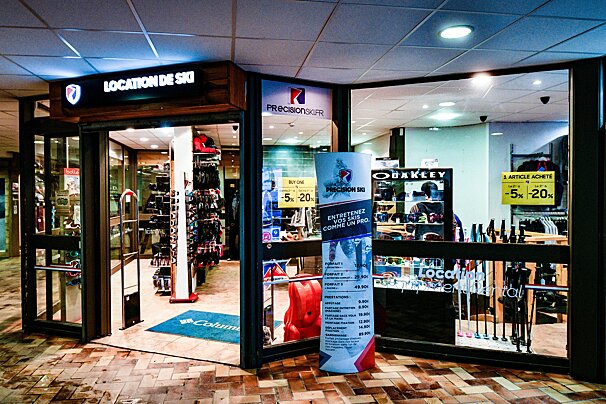 A well-lit ski rental shop storefront (