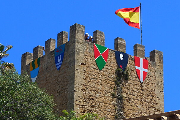A turret with flags at Capdepera Medieval Fair