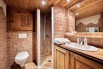 A bathroom with a toilet a sink and a mirror