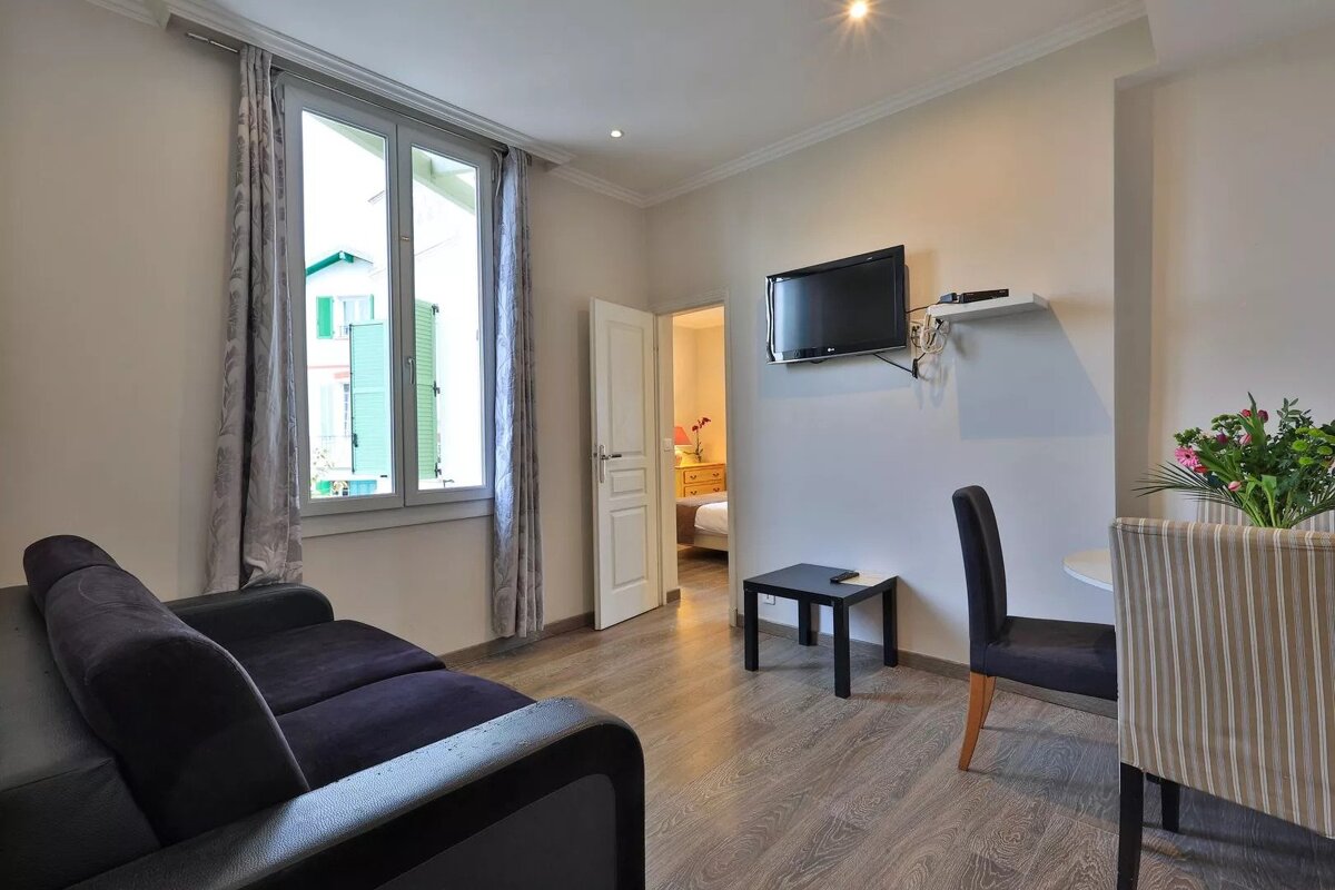 A living room with a couch and a flat screen tv