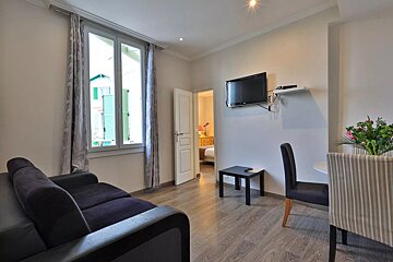A living room with a couch and a flat screen tv