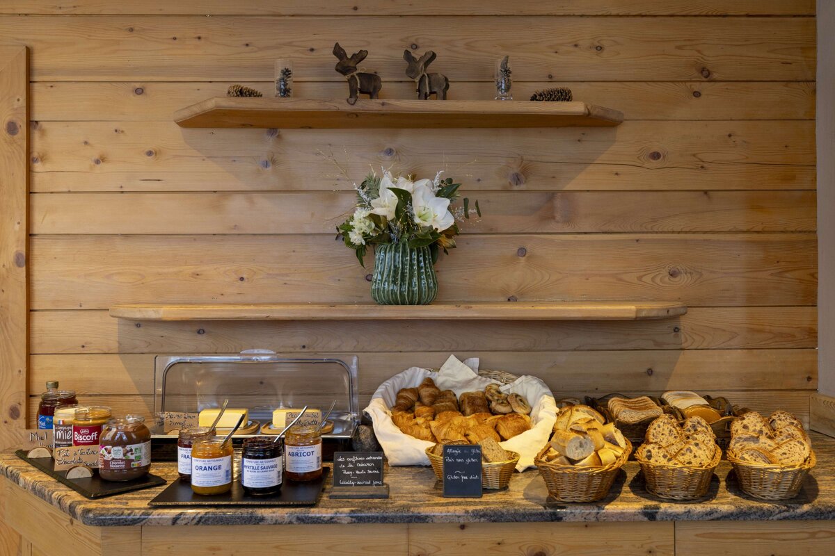 A wooden shelf with a vase of flowers on it