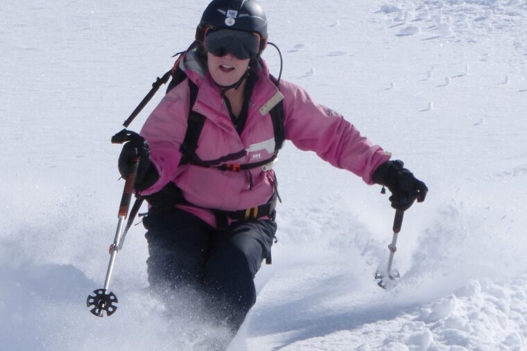 a woman in a pink ski jacket